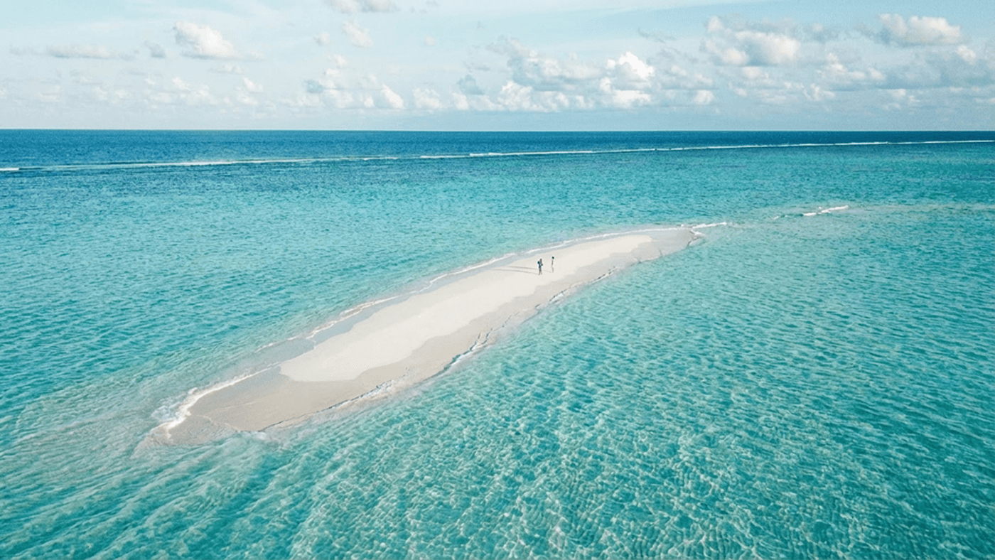 Aerial view of a tropical Maldives island with turquoise waters